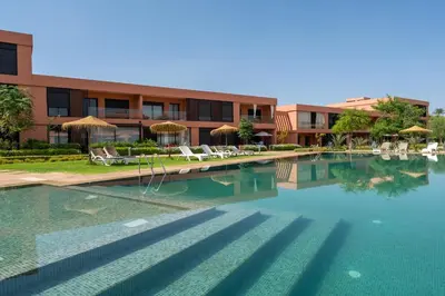 a swimming pool in front of a building at Charming two-bedroom with terrace in Marrakesh in Marrakech