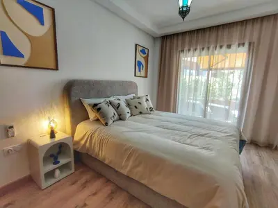 a bedroom with a large bed and a window at Charming two-bedroom with terrace in Marrakesh in Marrakech