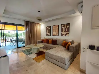 a living room with a couch and a table at Charming two-bedroom with terrace in Marrakesh in Marrakech