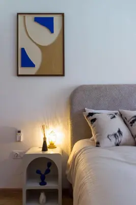 a bedroom with a bed and a nightstand with a lamp at Charming two-bedroom with terrace in Marrakesh in Marrakech