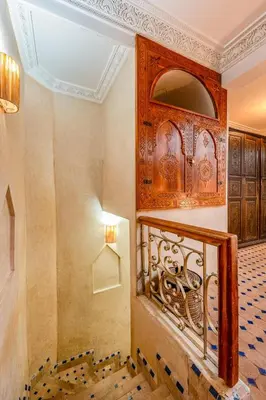 a room with a staircase with a mirror on the wall at Elegant 3-Bedroom Duplex with Pool in Marrakech
