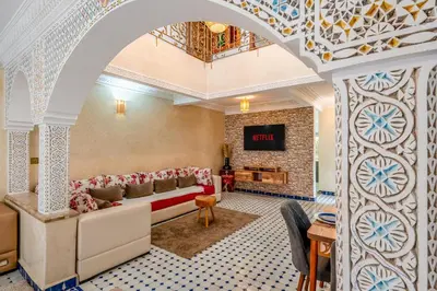 a living room with a couch and a fireplace at Elegant 3-Bedroom Duplex with Pool in Marrakech
