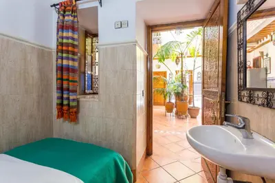 a bathroom with a sink and a mirror and a tub at Hotel Atlas in Marrakech