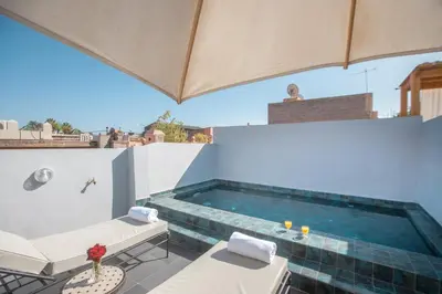 a swimming pool on the roof of a house at Ryad Marrakech in Marrakech