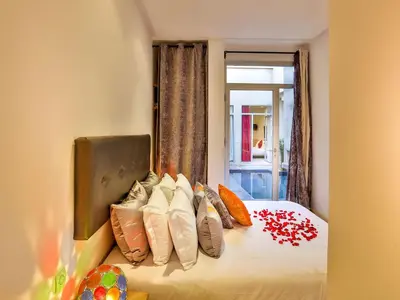 a bedroom with a bed with pillows on it at Ryad Marrakech in Marrakech