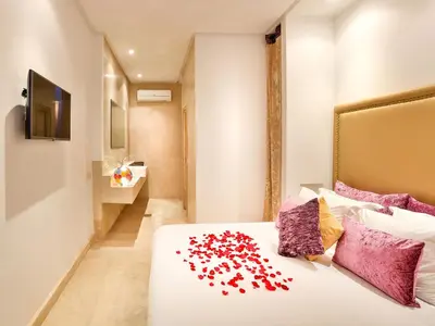 a bedroom with a bed with red hearts on it at Ryad Marrakech in Marrakech