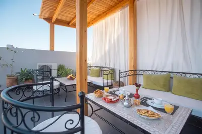 a balcony with a table with food on it at Ryad Marrakech in Marrakech