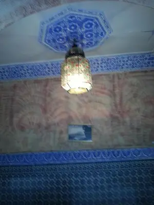 a chandelier hanging from a ceiling in a room at Riad Dar Kader chambre bleue in Marrakech