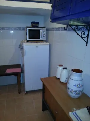 a kitchen with a microwave on top of a refrigerator at Riad Dar Kader chambre bleue in Marrakech