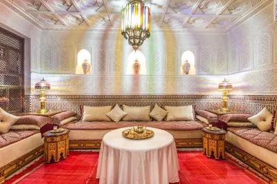 a living room with couches and a table at Riad Lamya Marrakech in Marrakech