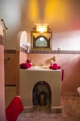 a bathroom with a sink and a mirror at Riad Lamya Marrakech in Marrakech