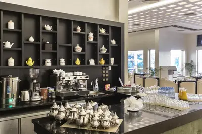 a restaurant with a counter with dishes on it at Savoy Le Grand Hotel Marrakech in Marrakech