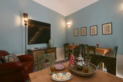 a living room with a table and some chairs at Riad Dar Ayur in Marrakech