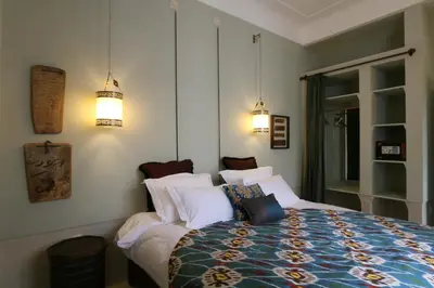 a bedroom with a bed with white pillows at Riad Dar Ayur in Marrakech