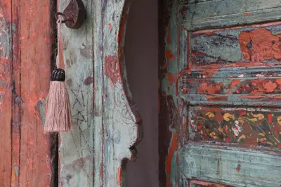 a wooden door with a tassel next to a painting at Riad Dar Ayur in Marrakech