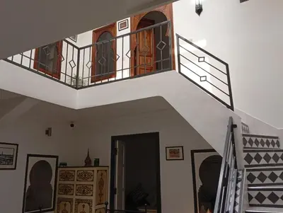 a staircase in a house with a balcony at Ryad Ayad in Marrakech