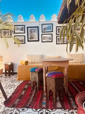 a living room with a table and a couch at Riad Argan in Marrakech