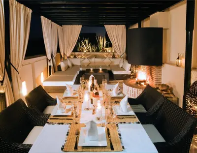 a dining room with a long table and chairs at Riad Adore in Marrakech