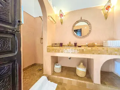 a bathroom with a sink and a mirror at Riad des Lys in Marrakech