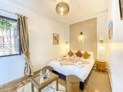 a bedroom with a bed with two elephants on it at Riad des Lys in Marrakech