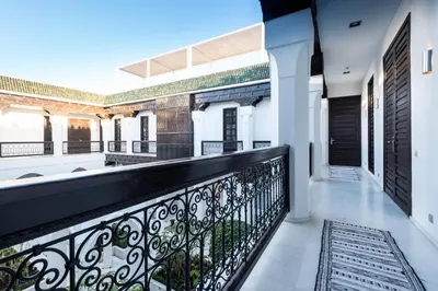 a balcony with a black railing and a door at Riad Elisa & Spa in Marrakech