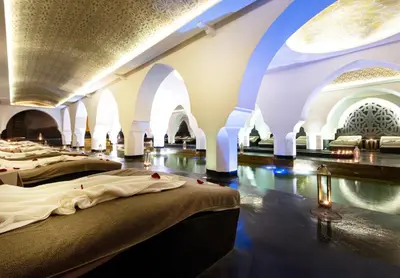 a room with three beds in it with arches at Riad Elisa & Spa in Marrakech