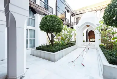 an internal courtyard of a building with a tree at Riad Elisa & Spa in Marrakech