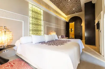 a bedroom with a large white bed and a window at Riad Elisa & Spa in Marrakech