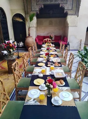 a long table with plates of food on it at Riad Boustane & SPA in Marrakech