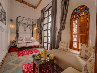 a living room with a couch and a table at Palais Tinmel Marrakech in Marrakech