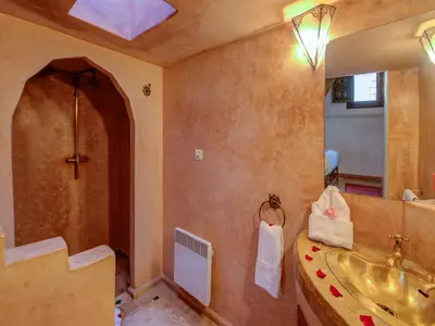a bathroom with a sink and a shower and a sink at Palais Tinmel Marrakech in Marrakech