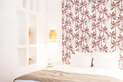 a bedroom with a bed with a floral wallpaper at Riad Sashema in Marrakech