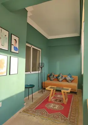 a living room with a couch and a table at Dar Guéliz in Marrakech