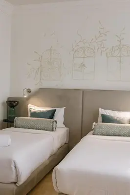 two beds sitting next to each other in a room at Dar Guéliz in Marrakech