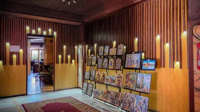 a room with a bunch of pictures on the wall at Hôtel Les Ambassadeurs in Marrakech
