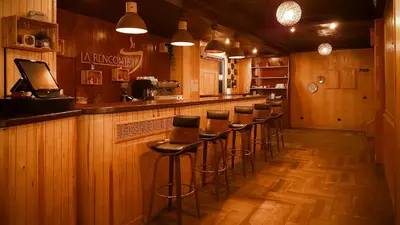 a bar with a row of stools in a restaurant at Hôtel Les Ambassadeurs in Marrakech