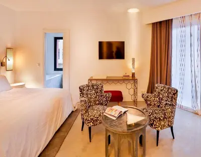 a hotel room with a bed and a table and chairs at 2Ciels Boutique Hôtel in Marrakech