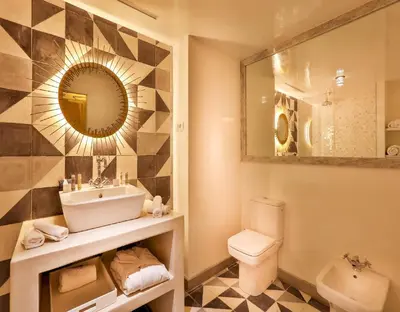 a bathroom with a sink and a toilet and a mirror at 2Ciels Boutique Hôtel in Marrakech