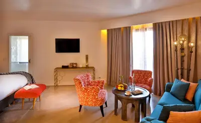 a living room with a bed and a couch and chairs at 2Ciels Boutique Hôtel in Marrakech