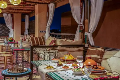 a dining room with a table with food on it at Riad Sun of Kech in Marrakech