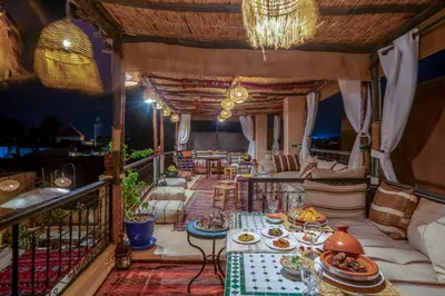 a balcony with a table with food on it at Riad Sun of Kech in Marrakech