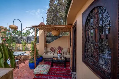 an outdoor patio with a gate and a couch at Riad Sun of Kech in Marrakech