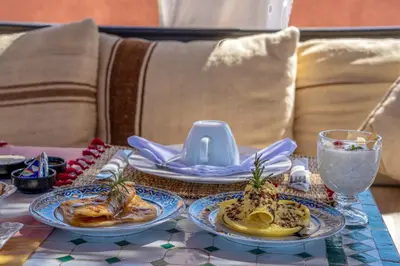a table with two plates of food on a table at Riad Sun of Kech in Marrakech