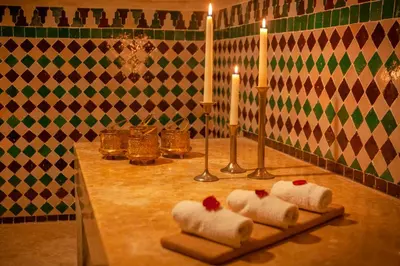 a table with three towels and candles on it at Dar Al Walidine in Marrakech