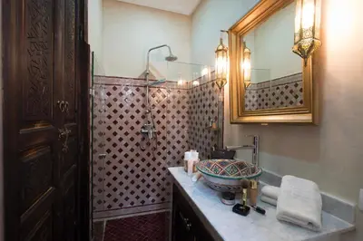 a bathroom with a sink and a mirror at Dar Al Walidine in Marrakech