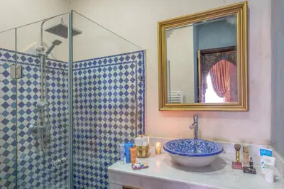 a bathroom with a sink and a glass shower at Dar Al Walidine in Marrakech