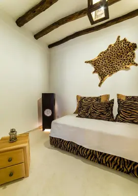 a bedroom with a bed with a leopard cut out on the wall at Riad See Moon And Spa in Marrakech