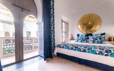 a bedroom with a bed and a large window at Riad See Moon And Spa in Marrakech