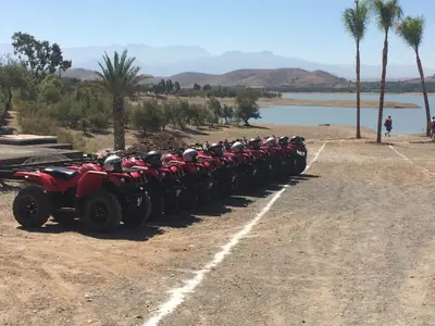 a group of atvs parked in a line next to a lake at Riad See Moon And Spa in Marrakech