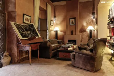 a living room with a piano and a living room with a fireplace at Riad Noir d'Ivoire in Marrakech